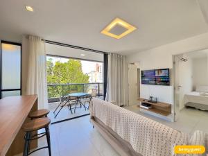 ein Schlafzimmer mit Bett und ein Balkon mit Fernseher in der Unterkunft JSmart Dom in Fortaleza