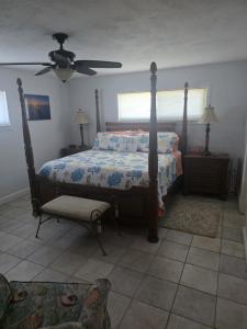 a bedroom with a bed and a ceiling fan at Blue Paradise - 7 DAY MINIMUM STAY in Marathon