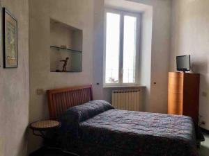 een slaapkamer met een bed en een raam bij Relax in Darsena - Savona in Savona
