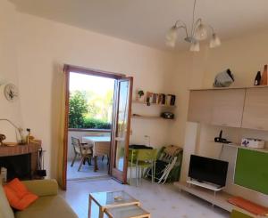 a living room with a couch and a table at Casa Marina in San Nicola Arcella +12 photos