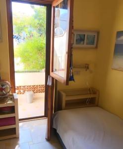 a small room with a bed and a window at Casa Marina in San Nicola Arcella