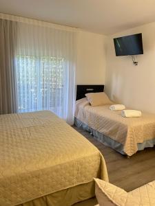 Postel nebo postele na pokoji v ubytování Nuevo Hotel del Faro Punta del este