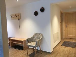 a room with a chair and a desk and a door at Katharina Von Allmen in Wengen