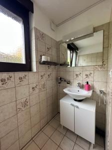 a bathroom with a sink and a mirror at Beautiful apartment near Luzern, view to Rigi,Pilatus Mountain in Luzern +15 photos