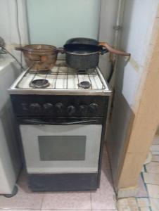 a stove with two pots on top of it at Affordable downtown studio steps to sea free wifi in Alexandria