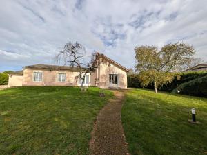 ein Haus mit einem Rasen davor in der Unterkunft Villa Mousse, Maison 4Ch 6 Lits à 17 min du Futuroscope in La Celle-sous-Gouzon