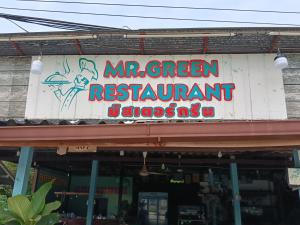 a sign for a restaurant on the side of a building at Easy sleep in Ban Mo Nae