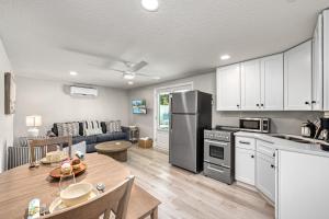a kitchen and living room with a table and a refrigerator at Mimosa - 5251B in Siesta Key