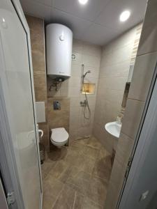 a bathroom with a toilet and a sink at Numbers in Ruse
