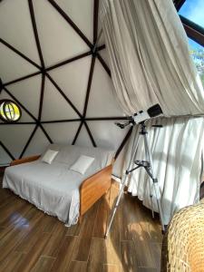 a room with a bed and a camera in a tent at Domo na praia - Arraial D'Ajuda in Arraial d'Ajuda