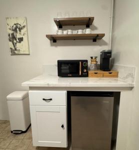 a white counter with a microwave on top of it at Charming Yosemite Basecamp - Walk to Downtown in Mariposa