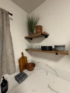 a corner of a room with wooden shelves and a table at Charming Yosemite Basecamp - Walk to Downtown in Mariposa +3 photos