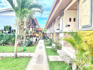 a building with palm trees in front of it at Puspa Guest House Lembongan in Nusa Lembongan +11 photos