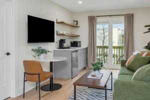 a living room with a couch and a table at Glenbrook Suites in Stamford