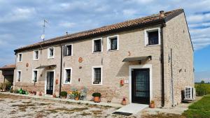 a large brick building with its door open at Agriturismo La Fornetta in Ferrara