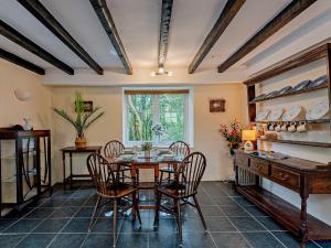 a dining room with a table and chairs and a window at 2 Bed in Machynlleth 93078 in Cemmaes +20 photos