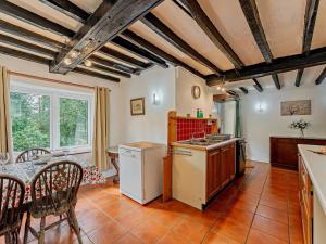 a kitchen and dining room with a table and chairs at 2 Bed in Machynlleth 93079 in Cemmaes