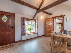 a dining room with a table and a window at 1 bed in Machynlleth 85207 in Darowen