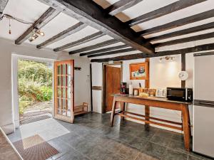 a kitchen with a table and a refrigerator at 2 Bed in Machynlleth 93082 in Cemmaes