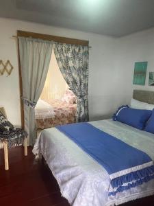 Ένα ή περισσότερα κρεβάτια σε δωμάτιο στο Hospedaje Finca Talulos