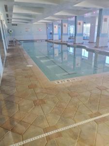 an empty swimming pool in a building at Sunkissed-Modern Oceanfront Condo Daytona Beach in Daytona Beach