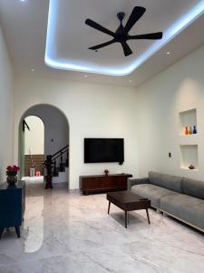 a living room with a couch and a flat screen tv at Cozy Home for Family, Friends & Work Trips in Buon Ma Thuot