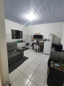 un salon avec un canapé et une cuisine dans l'établissement Casa completa na Enseada, Guarujá, à Guarujá