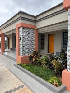 a home with a brick and stone facade at EuniBot Guest House in Francistown