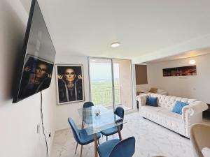 a living room with a white couch and a glass table at Wow que vista!! Frente Ecoparque 7min CC Buenavista in Puerto Colombia