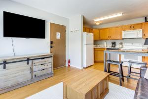 a kitchen with a flat screen tv on the wall at Less Than 1 Mi to Big Sky Resort Quiet Mtn-View Retreat in Big Sky Mountain Village