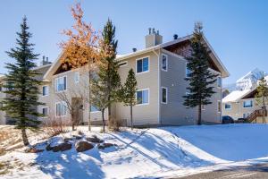 a house in the snow with trees in front of it at Less Than 1 Mi to Big Sky Resort Quiet Mtn-View Retreat in Big Sky Mountain Village +16 photos
