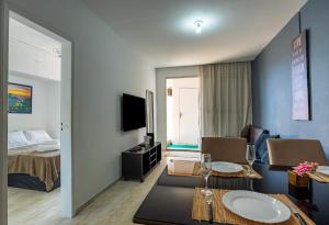 a living room with a room with a bed and a table at Cobertura posto 5 in Rio de Janeiro