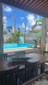 a patio with a table and a swimming pool at Enjoy summer with the family on Camboinha beach in Cabedelo +17 photos