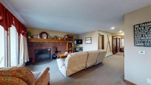a living room with a couch and a fireplace at Sunrise - W Glade K-5 in Killington