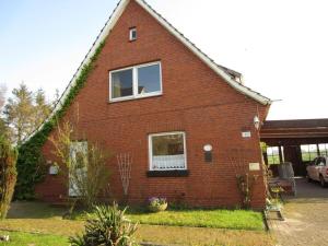 a red brick house with a window at Holiday home in Balje with Wi-Fi in Balje