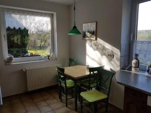 a kitchen with a table and chairs and a window at Holiday home in Balje with Wi-Fi in Balje