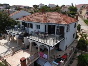 an overhead view of a white house with a balcony at Apartments by the sea Maslinica, Solta - 774 in Grohote