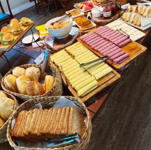 a table with many different types of bread and pastries at Espaço Tajj in São Roque