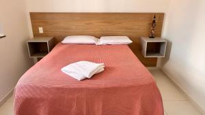 a bedroom with a bed with two towels on it at Dona Olivia Residencial in Vitória da Conquista +11 photos
