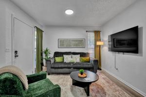 a living room with a couch and a table at Near Boone Pickens Stadium - Stillwater Stay in Stillwater
