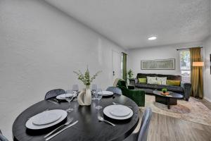 a dining room with a table and chairs and a living room at Near Boone Pickens Stadium - Stillwater Stay in Stillwater