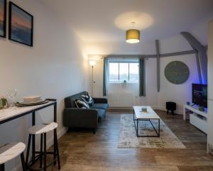 a living room with a couch and a table at Stylish, Spacious 1 Bedroom Apartment, central in Bristol