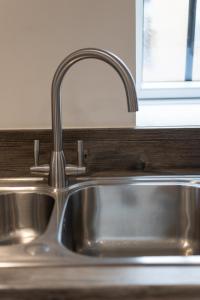 a stainless steel sink in a kitchen with a window at Stylish, Spacious 1 Bedroom Apartment, central in Bristol +26 photos
