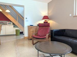 a living room with a couch and a table at Gîte au Calme Proche de Nancy avec Terrasse Privative et Parking - FR-1-584-103 in Champenoux +12 photos