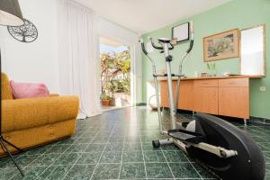 a living room with an exercise bike on the floor at Seaside family friendly house with a swimming pool Drvenik Veliki, Drvenik - 22085 in Veliki Drvenik