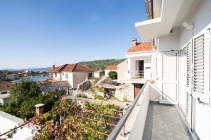 a balcony with a view of a city at Seaside family friendly house with a swimming pool Drvenik Veliki, Drvenik - 22085 in Veliki Drvenik