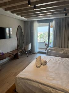 a hotel room with a bed with a towel on it at ONE GATE Pyramids View INN in Cairo