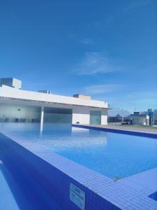 a large swimming pool in front of a building at Refúgio do Sol in João Pessoa