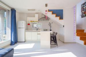 a kitchen with a counter and a kitchen with a staircase at Hue Bless Spa Pension Gapyeong in P'yŏngban-ni +11 photos