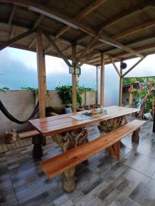 a large wooden table on top of a patio at Cabanas LA CASITA BRISA DO MAR in Navegantes